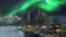 Beautiful rocky mountains and lakes with green aurora.
