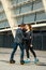 Beautiful roller skater couple with hipster style skating after the rain.