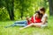 Beautiful romantic couple with tablet pc at summer green park