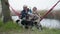 Beautiful romantic elderly middle-aged grandparents relaxing, having fun together with little boy sitting in hammock