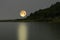 Beautiful and romantic full moon over the lake