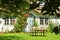 Beautiful and romantical entrance and garden of an old german farmhouse with framework and blooming plants