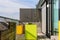 Beautiful roof terrace with wooden floor with yellow and green planters for urban gardening and flowering trees