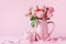Beautiful rose flowers in pink vase and gift box for Womens day or Mothers day greeting card