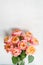 Beautiful roses flowers in a vase on a table . Bouquet of pink and orange multicolor flower. Decoration of home