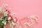 beautiful roses next to pearls and perfume on wooden background.