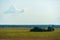 A beautiful rural field against a background of blue sky and clouds. Agro-industrial complex for the cultivation of cereals, wheat