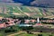 Beautiful rural landscape with church and houses and fields, view from Coltesti