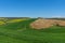 Beautiful rural landscape, cypress trees, green field and blue sky in Tuscany near Pienza. Italy