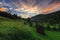 Beautiful rural landscape at sunset. Haystack in the meadow under a beautiful sunset sky with clouds.