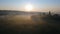 Beautiful rural panorama. dawn and fog. Mill and church in the field. Morning in the Ukrainian village countryside