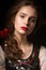 Beautiful Russian girl in national dress with a braid hairstyle and red lips. Beauty face.