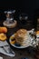 Beautiful rustic breakfast - pancakes with blueberries, peach, Gypsophila flowers, moka coffee machine, wooden table