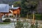 Beautiful rustic residence surrounded by green trees and foliage on a snowy day in Villa La Angostura