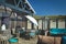 Beautiful rustic wooden and teal colored interior design of `Paal 19` beach pavilion terrace on island Texel on a sunny summer day