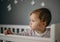 Beautiful, sad little girl indoors portrait in children`s room