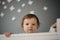 Beautiful, sad little girl indoors portrait in children`s room