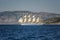 Beautiful sailing ship in the sea on a background of mountains