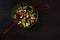 Beautiful salad on the black wood background