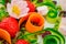 Beautiful salad with edible flowers, cucumber, carrot, dried cranberries, strawberry