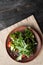 Beautiful salad serving on a dining napkin on a plate lined Greek salad