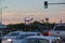 Beautiful San Diego cityscape view. Vehicles on front and landing aircraft on evening sky on background.