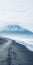 Beautiful Sand Beach Surrounded By Snow Capped Mountains In Iceland