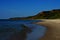 The beautiful sandy beach against the background of the calm sea fnd mountains