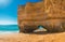 Beautiful sandy beach with giant cliff with arch near Portimao in Algarve region, Portugal, Europe