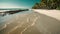 a beautiful sandy beach with palm trees in the background, providing a serene tropical atmosphere, A deserted sandy beach with the