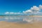 Beautiful sandy beach with sky reflection on a sunny day. Nature tropical background with copy space. Low tide at Elliot Heads