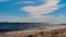 A beautiful sandy beach, waves and blue sky on the beach.