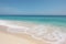 Beautiful sandy beach with white sand and rolling calm wave of turquoise ocean on Sunny AI generated