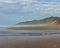 Beautiful and sandy Beverly Beach shore with forested mountains in the distance