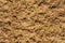 Beautiful sandy light brown background bake for design. Close-up of sand surface