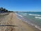 Beautiful sandy Torre Canne beach in Italy next to the sea with calm foamy waves