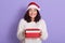 Beautiful Santa girl with christmas holidays gifts looking directly at camera with happy smile, brunette lady with charming happy