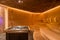Beautiful sauna room design with a wooden bench and sauna rocks in the center