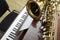 Beautiful saxophone on piano, closeup. Space for text