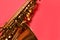 Beautiful saxophone on red background, closeup view