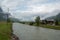Beautiful scene of aare river with wooden houses in small village  with clouds sky for background
