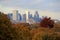 Beautiful scene of cityscape rising over tree line