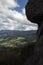 Beautiful scene of countryside and mountains viewd from mossy rocky cliff