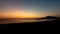 Beautiful scene of dark orange sunset sky and silhouette Mount Vesuvius on the horizon in Italy