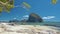 Beautiful scene of El Nido coastline with tropical island in background framed by moving tree branches. Palawan