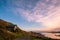 Beautiful scene of a landscape in a rural area beside the ocean at sunset. Cosy Nook, New Zealand. I