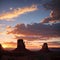 a beautiful scene of the Monument Valley Sunset under a colorful sky.