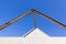 Beautiful scene of Triangular roof frame against Clear blue sky background in town