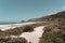 Beautiful scenery of a beach near the sea surrounded by rocky mountains in Florianopolis, Brazil