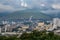 Beautiful scenery of Beppu cityscape with Steam drifted from public baths and ryokan onsen